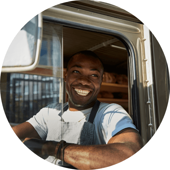 A truck driver smiling through a window